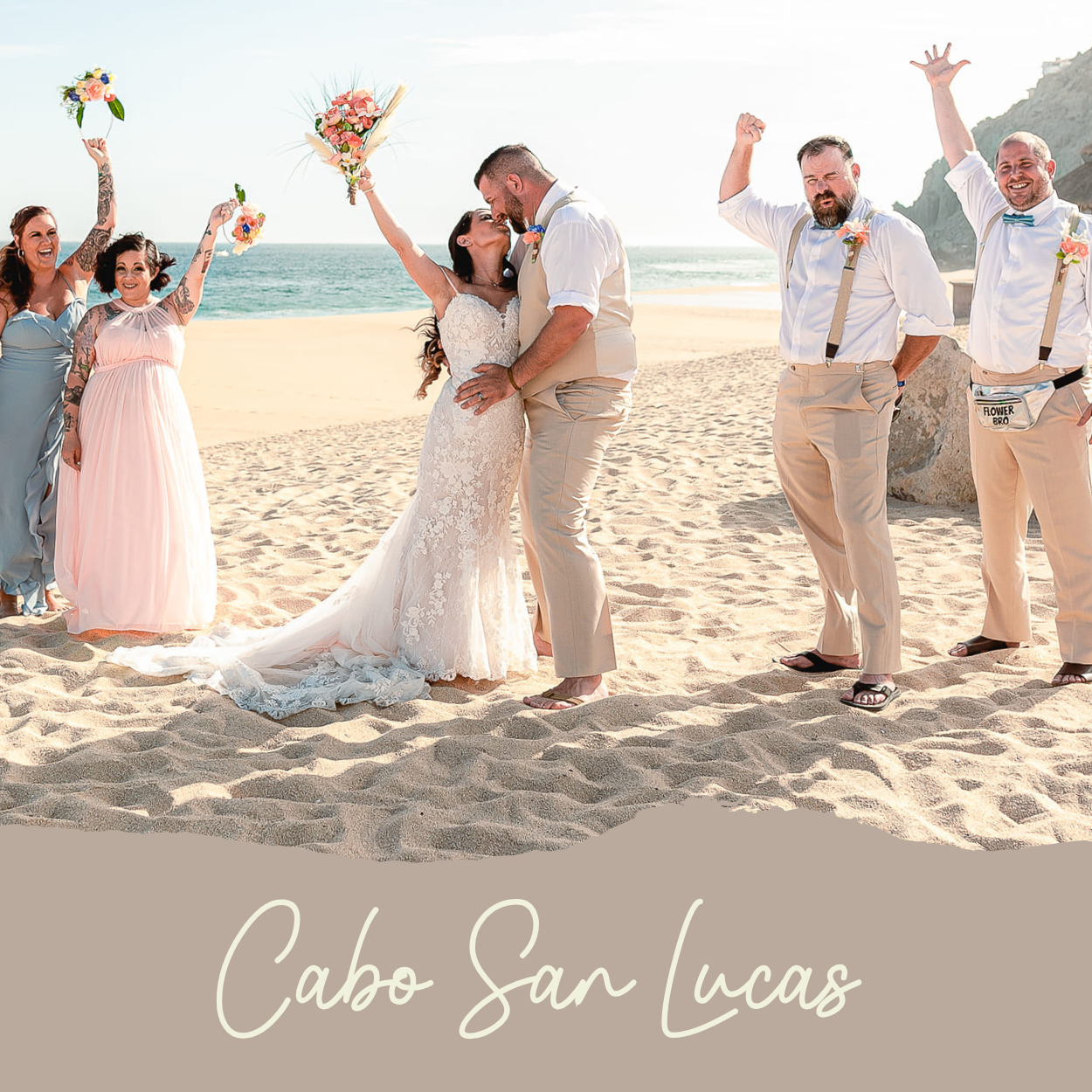 a wedding couple kissing in celebration on the beach in Cabo San Lucas at the Sandos FInestra Resort with the cliffs in the background